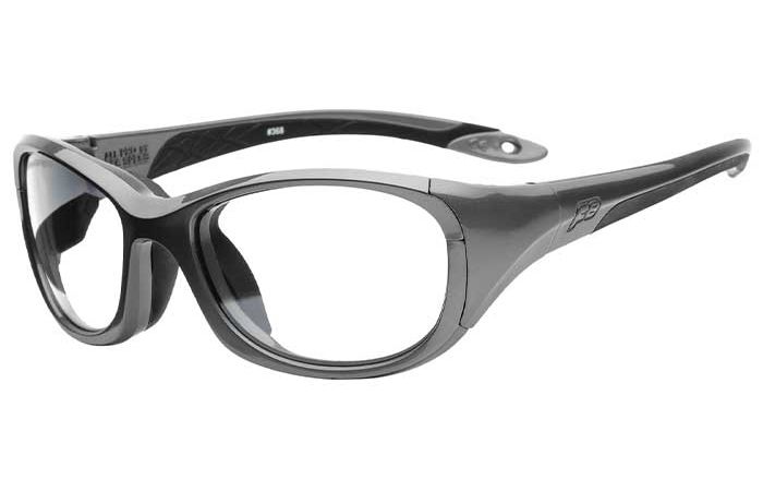 A pair of black and grey sports sunglasses with wraparound frames and dark-tinted lenses, meeting high impact resistance standards. The temples feature a hole near the end, possibly for attaching a strap, and a subtle logo. The sleek, aerodynamic design of these RecSpecs - All Pro XL goggles is suited for active wear.