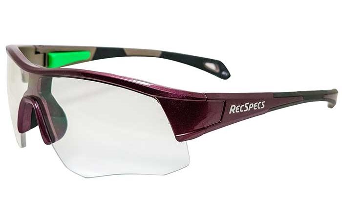 A pair of RecSpecs - Contact glasses with a burgundy frame and shatterproof lenses. The temples are sleek with a dual-color design, incorporating black and green accents. The glasses feature a modern, wraparound style for athletic use, meeting high impact standards.