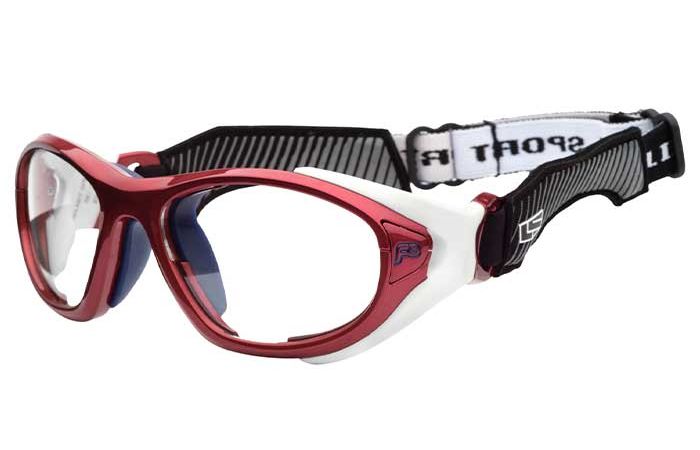 Red sports goggles known as RecSpecs Helmet Spex feature a flexible black and white adjustable strap. The clear lenses and frame, with a white accent on the sides, provide excellent visibility. The strap is branded with the word "SPORT," meeting high impact resistance standards for optimal protection.