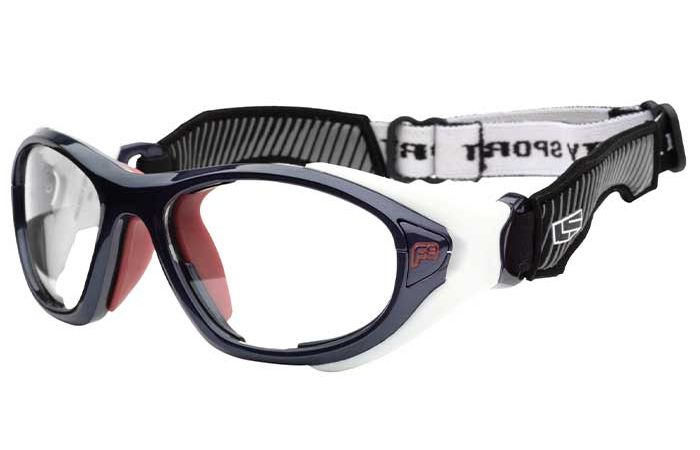 RecSpecs Helmet Spex sports safety goggles with a navy blue and white frame, clear lenses, and an adjustable black and white strap. Designed for eye protection during physical activities, these goggles meet impact resistance standards to ensure maximum safety.