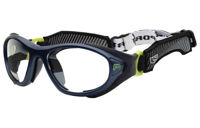 Image shows a pair of sport safety goggles, RecSpecs Helmet Spex XL, with black frames, clear lenses, and an adjustable elastic strap. The frame has lime green accents and a logo on the side. Meeting impact resistance standards, the strap features black and white zigzag patterns for added grip and style.