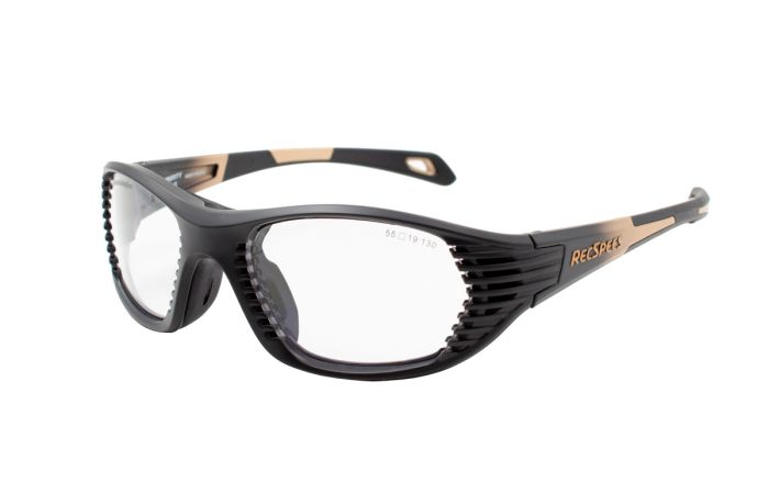 A pair of black and orange RecSpecs Maxx Air sports goggles with clear lenses. The frame features a wraparound design with ribbed detailing on the sides for added grip and comfort. The temples are curved with the brand name RecSpecs visible on the side.