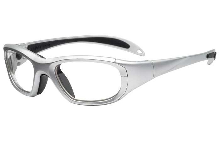 A pair of sporty, silver-framed RecSpecs Maxx 20 safety glasses with clear lenses and black interior padding. The arms of the glasses are slightly curved with black accents at the ends. The design appears to offer extra protection around the eyes.