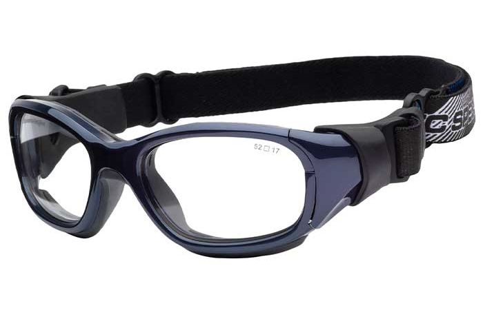 A pair of RecSpecs Slam Goggle by RecSpecs with clear lenses, a dark blue frame, and an adjustable black elastic strap. The strap features a buckle and a small design near the end. The frame has a small print on the inside with specifications "52 □ 17".