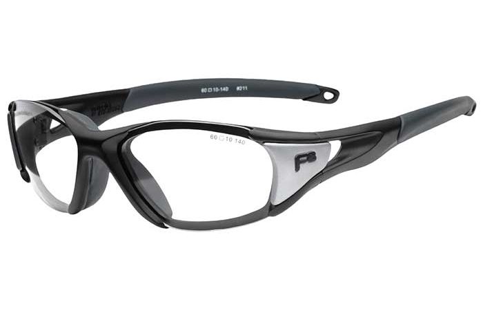 A pair of RecSpecs - Velocity sports glasses featuring a sturdy black frame with grey accents. The lenses are clear and the frame has a wraparound design, providing extra support around the temples. The arms have loops on the ends, likely for attaching a strap.