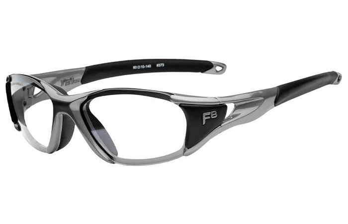 A pair of RecSpecs - Velocity sports glasses with clear lenses is displayed at an angle. The frame has a sleek, aerodynamic design with a matte finish. The temples are curved for a secure fit, and the number “87S” is printed on the inner side of the left temple.