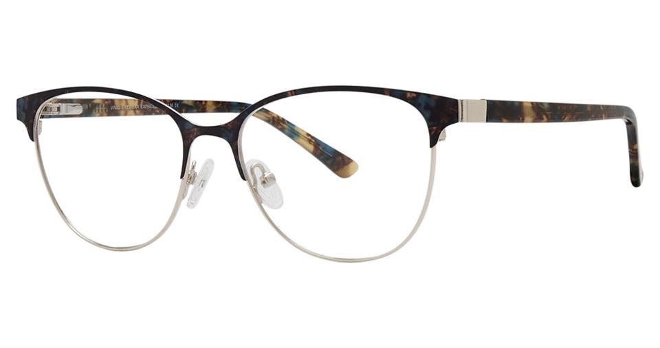 A pair of Vivid Expressions 1130 eyeglasses with a sleek, thin metal frame featuring a tortoiseshell pattern on the upper rims and temples. These two-tone glasses boast adjustable nose pads and a minimalistic design, seamlessly combining modern style with classic detailing.