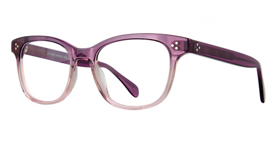 The Vivid Grand 7503 eyeglasses feature a purple frame with a transparent gradient design that becomes clearer towards the bottom. These versatile, stylish glasses have a classic rectangular shape with slightly pointed corners and solid purple arms with a glossy finish, made from high-quality plastic frames.